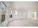 Spacious bedroom with large windows providing natural light, neutral carpet, and an ensuite bathroom at 5191 S Hannibal Way, Centennial, CO 80015