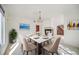Chic dining area with modern decor, a beautiful chandelier, and a view into a living room with fireplace at 5191 S Hannibal Way, Centennial, CO 80015