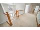 View of the foyer showcasing the wooden banister staircase, chandelier, and a glimpse of the home's entry at 5191 S Hannibal Way, Centennial, CO 80015
