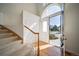 Bright foyer features wood floors, carpeted stairs, and a view of the front yard through the open doorway at 5191 S Hannibal Way, Centennial, CO 80015