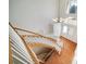 Staircase showing wood and white trim leading to the front door under a high ceiling and chandelier at 5191 S Hannibal Way, Centennial, CO 80015