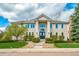 Stunning two-story home featuring a manicured lawn, mature trees, and a grand entrance with double doors at 5191 S Hannibal Way, Centennial, CO 80015