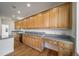 Traditional kitchen featuring wood cabinets, granite countertops, and stainless steel appliances at 5191 S Hannibal Way, Centennial, CO 80015