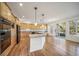 Modern kitchen featuring wood cabinets, a large center island, and stainless steel appliances at 5191 S Hannibal Way, Centennial, CO 80015
