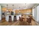 Spacious kitchen with a large island, stainless steel appliances, and a dining area with seating at 5191 S Hannibal Way, Centennial, CO 80015
