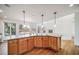 Open kitchen layout with a large island, granite countertops, hardwood floors, and many windows at 5191 S Hannibal Way, Centennial, CO 80015