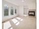A bright living room features three large windows and a fireplace, offering a comfortable and inviting space at 5191 S Hannibal Way, Centennial, CO 80015