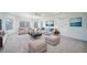 Bright living room with neutral furniture, plush carpeting, and natural light from multiple windows at 5191 S Hannibal Way, Centennial, CO 80015
