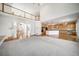 Expansive living room with a fireplace, staircase, and an open-concept design connected to the kitchen at 5191 S Hannibal Way, Centennial, CO 80015
