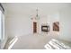 Bright living room with a decorative fireplace and chandelier, leading to a dining area through a doorway at 5191 S Hannibal Way, Centennial, CO 80015