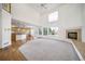 Spacious living room featuring a fireplace, large windows, and access to the kitchen at 5191 S Hannibal Way, Centennial, CO 80015