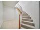 Bright and airy staircase featuring neutral carpeting and a wooden railing at 5191 S Hannibal Way, Centennial, CO 80015