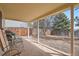Enjoy a spacious backyard with a covered patio, brick flooring, and a wood privacy fence at 7586 Chase St, Arvada, CO 80003