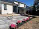 Landscaped backyard with a newly installed tiled patio, complete with flower beds at 7586 Chase St, Arvada, CO 80003