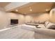 Spacious basement area featuring a comfortable sectional sofa and a large television at 7586 Chase St, Arvada, CO 80003