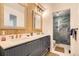 Bright bathroom featuring a double vanity with gold fixtures and a large walk-in shower at 7586 Chase St, Arvada, CO 80003