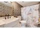 Stylish bathroom showcasing decorative wallpaper, a marble-patterned shower curtain and modern fixtures at 7586 Chase St, Arvada, CO 80003