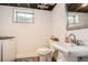 Basement bathroom features a single sink vanity and nearby laundry appliances at 7586 Chase St, Arvada, CO 80003