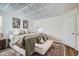 Bright bedroom features a textured ceiling, plush bedding, and a cozy seating area at 7586 Chase St, Arvada, CO 80003