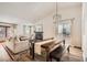 Open-concept living room and dining area with fireplace and hardwood floors and lots of natural light at 7586 Chase St, Arvada, CO 80003
