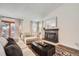 Bright living room boasts a fireplace, large windows, and elegant decor for a relaxing ambiance at 7586 Chase St, Arvada, CO 80003