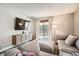 Comfortable living room featuring a plush gray sofa and sliding glass doors to the outside at 7586 Chase St, Arvada, CO 80003