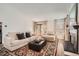 Inviting living room featuring a fireplace, comfortable seating, and a stylish area rug at 7586 Chase St, Arvada, CO 80003