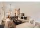 Spacious open-concept living room features hardwood floors, a fireplace, and large windows at 7586 Chase St, Arvada, CO 80003