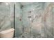 This modern shower features elegant blue tile, a glass door, and built-in shelving at 7586 Chase St, Arvada, CO 80003