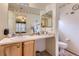Cozy bathroom with floral wallpaper and a vanity sink, including a view of the adjacent bedroom at 12835 Mayfair Way # C, Englewood, CO 80112
