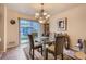 Cozy dining area featuring glass table, stylish chandelier, and access to outdoor space at 12835 Mayfair Way # C, Englewood, CO 80112