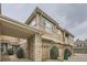 Stylish townhome showcasing stone accents, neutral siding, and a convenient carport at 12835 Mayfair Way # C, Englewood, CO 80112