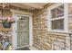 Charming front entrance featuring stone facade, decorative accents, and a welcoming door at 12835 Mayfair Way # C, Englewood, CO 80112