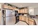Functional kitchen featuring wood cabinets, stainless steel appliances, and efficient layout at 12835 Mayfair Way # C, Englewood, CO 80112