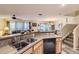 Inviting kitchen with sink, counter, and view to living room and dining area at 12835 Mayfair Way # C, Englewood, CO 80112