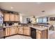 Well-equipped kitchen featuring wood cabinets, stainless appliances, and seamless layout at 12835 Mayfair Way # C, Englewood, CO 80112