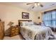 Comfortable main bedroom with wooden furnishings, a ceiling fan, and cozy quilt bedding at 12835 Mayfair Way # C, Englewood, CO 80112