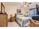 Comfortable main bedroom with wooden furnishings, a ceiling fan, and cozy quilt bedding at 12835 Mayfair Way # C, Englewood, CO 80112