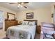 Comfortable main bedroom with wooden furnishings, a ceiling fan, and cozy quilt bedding at 12835 Mayfair Way # C, Englewood, CO 80112