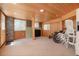 Finished basement features a door to the outside, stone walls, and tongue-and-groove ceiling at 6650 Village Rd, Parker, CO 80134