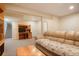 Finished basement with a workspace, television, and comfortable seating area at 6650 Village Rd, Parker, CO 80134