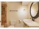 Quaint bathroom features a unique vanity, decorative mirror, and tiled shower at 6650 Village Rd, Parker, CO 80134