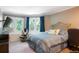 Comfortable bedroom featuring a bay window, gaming set up, and neutral color palette at 6650 Village Rd, Parker, CO 80134