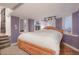 Bedroom featuring a light colored bed, hardwood floors, and three windows at 6650 Village Rd, Parker, CO 80134