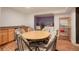 Open dining area features seating for six, a kitchenette, and hardwood floors at 6650 Village Rd, Parker, CO 80134