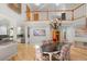 Open dining room with hardwood floors, views of the kitchen, and chandelier at 6650 Village Rd, Parker, CO 80134