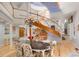 Bright dining room featuring high ceilings, hardwood floors, and a spiral staircase at 6650 Village Rd, Parker, CO 80134