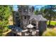 Distinctive stone castle home featuring a terrace and outdoor seating at 6650 Village Rd, Parker, CO 80134