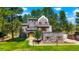 Unique stone castle-style home with mature trees and lush green lawn at 6650 Village Rd, Parker, CO 80134