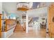 Spacious foyer with a curved staircase, wood floors, and bright natural light at 6650 Village Rd, Parker, CO 80134